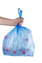 Hand hold blue plastic garbage bag with used PET bottles isolated on white background Royalty Free Stock Photo