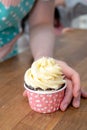 Hand hold chocolate cupcakes. Royalty Free Stock Photo