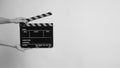 Hand hold clapperboard on whitw background.in black and white color. Royalty Free Stock Photo