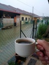 Hand hold coffee cup in flood background