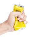 Hand hold compressed yellow aluminum can isolated on white background with clipping path Royalty Free Stock Photo