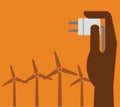 Hand hold eco power plug and Wind turbines Royalty Free Stock Photo