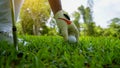 Hand hold golf ball with tee on course, golf course background Royalty Free Stock Photo