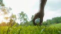 Hand hold golf ball with tee on course, golf course background Royalty Free Stock Photo