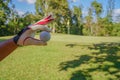 Hand hold golf ball with tee on course, golf course background Royalty Free Stock Photo