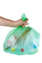 Hand hold green plastic garbage bag with used PET bottles isolated Royalty Free Stock Photo