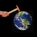 Hand hold a hammer hit the world .Elements of this image furnish Royalty Free Stock Photo