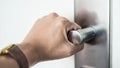 Hand hold handle of metal doorknob.