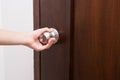 Hand hold handle of wood door Royalty Free Stock Photo