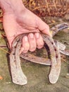 Hand hold horseshoe. Silver wornout brushed horseshoes Royalty Free Stock Photo