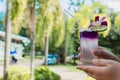 Hand hold Juice of Butterfly pea with lemon and ice in glass. Herb drink for refreshment. Royalty Free Stock Photo