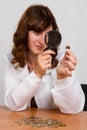 Hand hold magnifying glass and coins Royalty Free Stock Photo