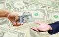 Hand hold many US Dollar with US Dollar banknote background. Royalty Free Stock Photo