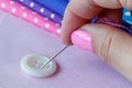 Hand hold needle sew a button Royalty Free Stock Photo