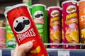 A buyer buys Pringles chips at a supermarket. Hand hold a new tube of Pringles Potato Chips. Minsk, Belarus 2022 Royalty Free Stock Photo
