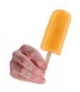 The male hand hold an orange popcicle ice cream Royalty Free Stock Photo