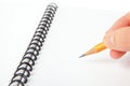 Hand hold a pencil writing on notebook Royalty Free Stock Photo