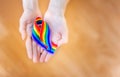 Hand hold a rainbow of LGBT tapes on a LIGHT background. Copy space The concept of homosexuals and LGBT people.