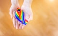 Hand hold a rainbow of LGBT tapes on a LIGHT background. Copy space The concept of homosexuals and LGBT people.