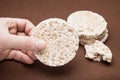 Hand hold rice bread on a brown background Royalty Free Stock Photo