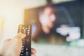 Hand hold Smart TV remote control with a television Royalty Free Stock Photo