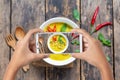 Hand hold smartphone takes photo green curry chicken for blog,photographer food