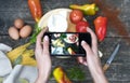 Hand hold smartphone woman takes photo healthy food for blog,photographer food Royalty Free Stock Photo