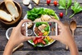Hand hold smart phone woman takes photo healthy food for blog,photographer food Royalty Free Stock Photo