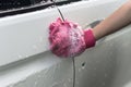 Hand hold sponge over the car for washing. Royalty Free Stock Photo