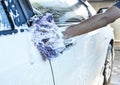 Hand hold sponge over the car for washing Royalty Free Stock Photo