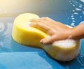 Hand hold sponge over car for washing Royalty Free Stock Photo
