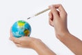 Hand hold a thermometer and globe