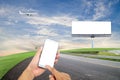 hand hold and touch screen smart phone with Blank billboard for Royalty Free Stock Photo