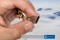 Hand hold USB Flash Drive double exposure with snow mountain wit