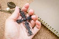 Hand hold vintage crucifix necklace with diary. Royalty Free Stock Photo