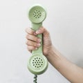 Hand hold vintage telephone green color Royalty Free Stock Photo