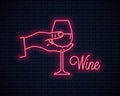 Hand hold wine neon sign. Male holding wine glass