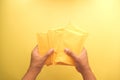 hand hold yellow paper bubble envelope top view