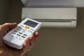 Hand holdind control switch of home air conditioner Royalty Free Stock Photo
