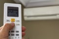 Hand holdind control switch of home air conditioner Royalty Free Stock Photo