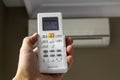 Hand holdind control switch of home air conditioner Royalty Free Stock Photo