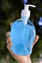 hand holdinf bottle of a virus sanitizer Royalty Free Stock Photo