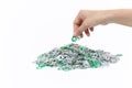 Hand holding aluminum cap can over a pile of cap can Royalty Free Stock Photo