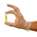 Hand holding ampule with yellow drug Royalty Free Stock Photo