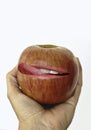 Hand holding an Apple Smacking lips Royalty Free Stock Photo