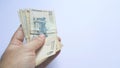 Hand holding argentinian money banknote with white background Royalty Free Stock Photo