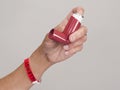 Hand holding asthma inhaler