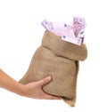 Hand holding bag with many banknotes Royalty Free Stock Photo