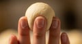 Hand holding a ball of dough Royalty Free Stock Photo