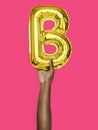 Hand holding balloon letter B Royalty Free Stock Photo